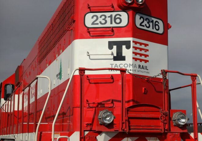 Close-up of a red and white Tacoma Rail locomotive head with the number 