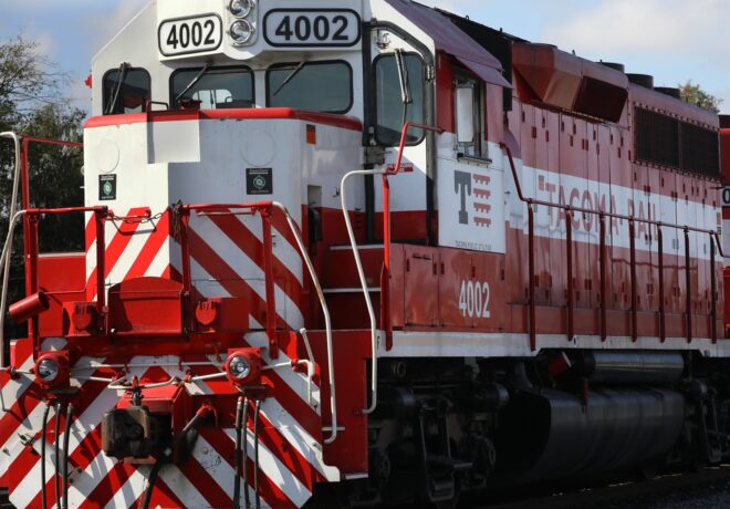 Close-up of a red and white Tacoma Rail locomotive head with the number 
